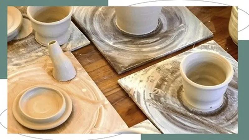 small thrown clay pots drying on boards