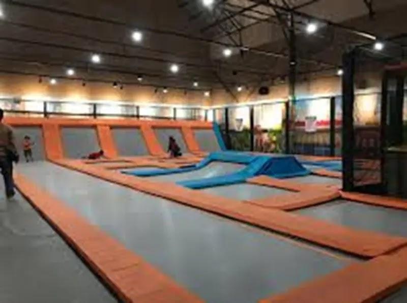 Indoor trampoline park with orange and blue trampolines