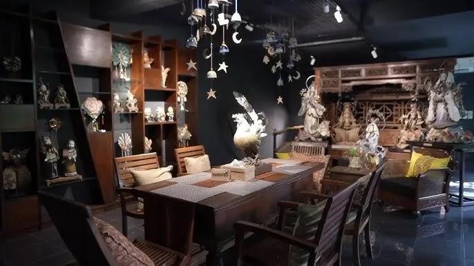 Antique shop with wooden dining table and sculptures