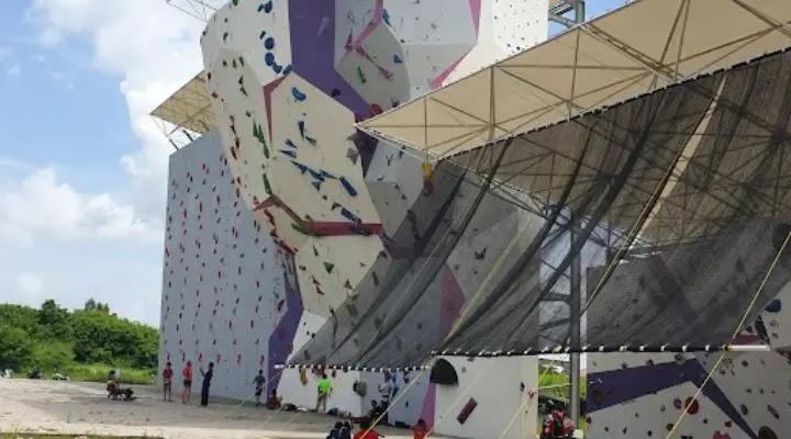 outdoor sport climbing wall with canopy and climbers