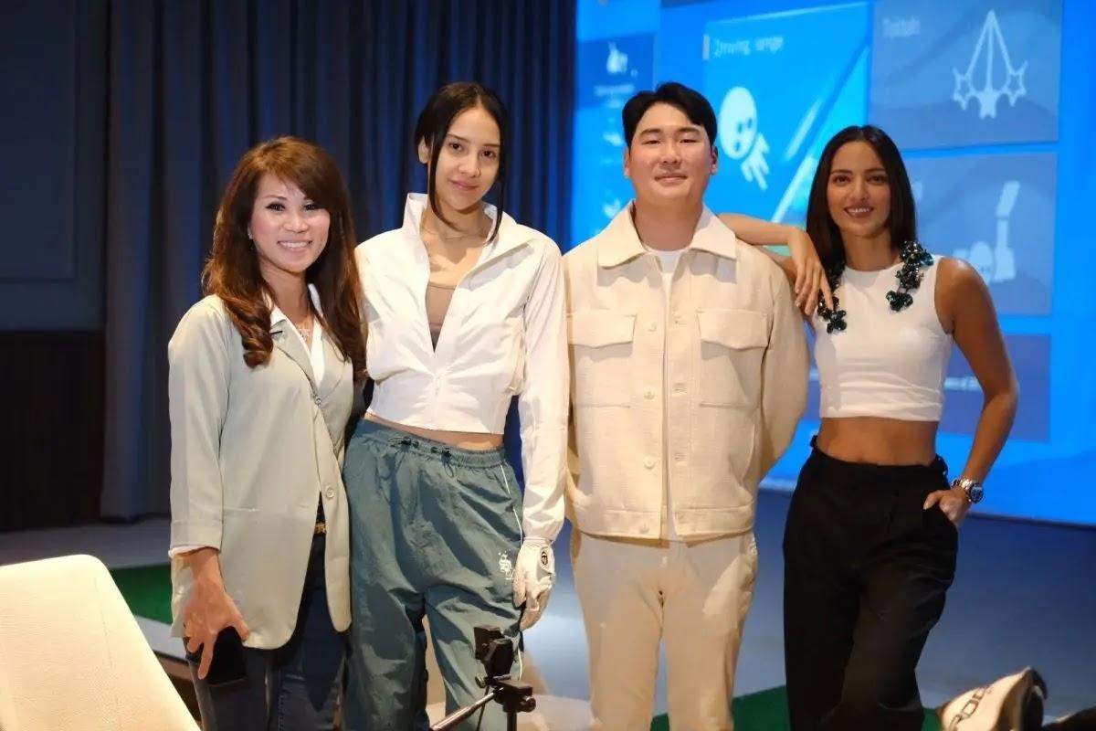 Four people smiling and posing at an indoor event