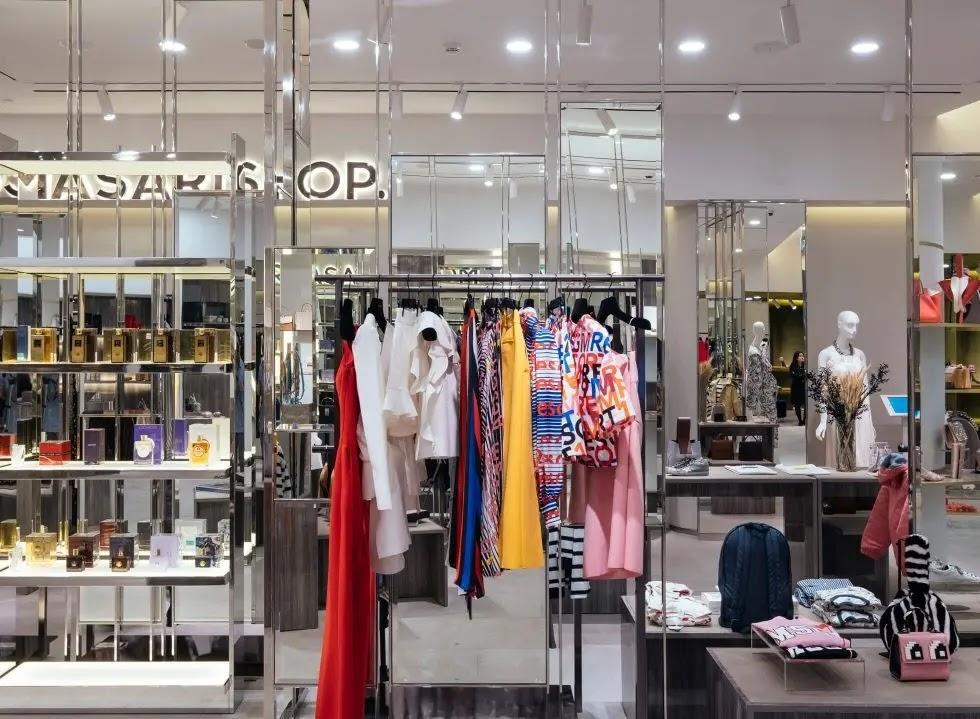 Clothing store window display with colorful dresses
