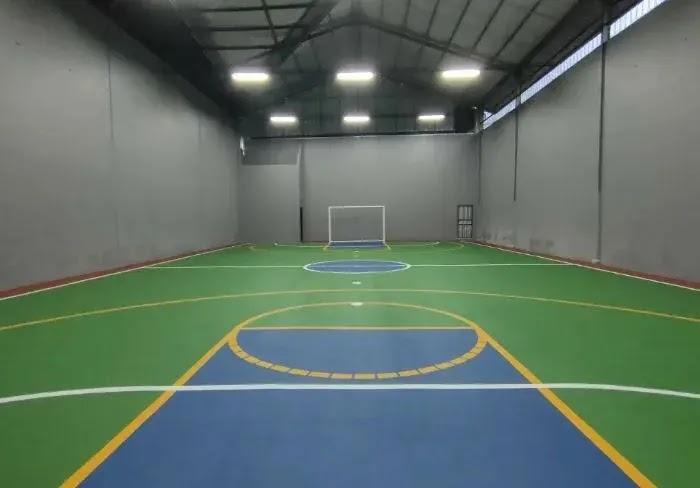 Indoor futsal court with green and blue painted floor
