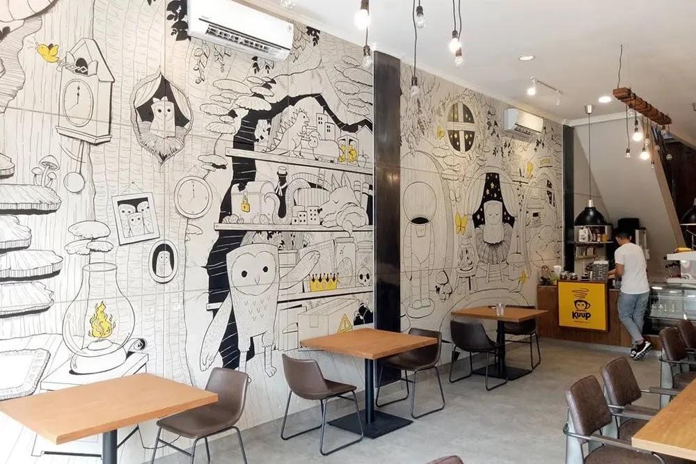 Cafe interior with black and white owl wall mural