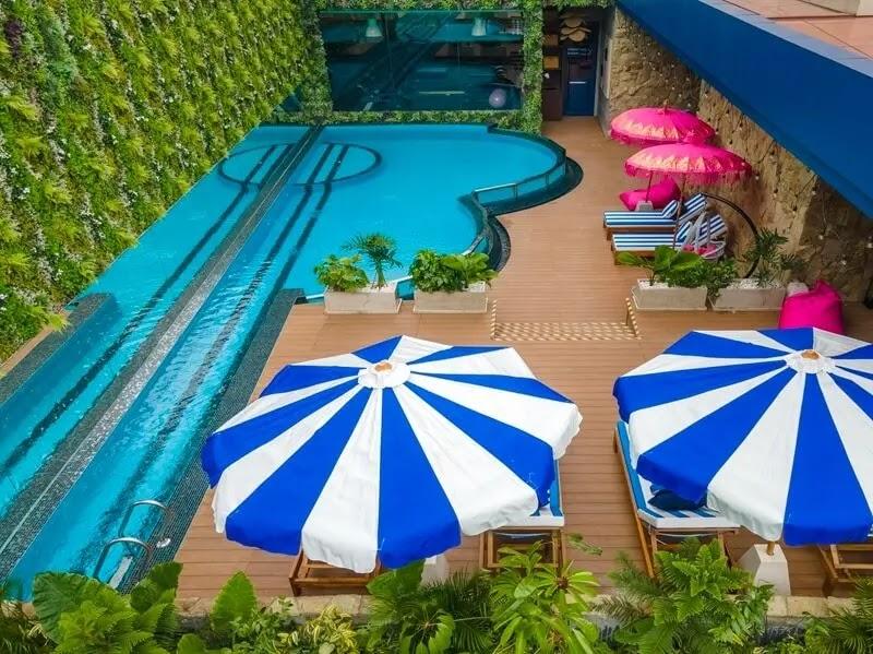 Pool deck with blue and white striped umbrellas