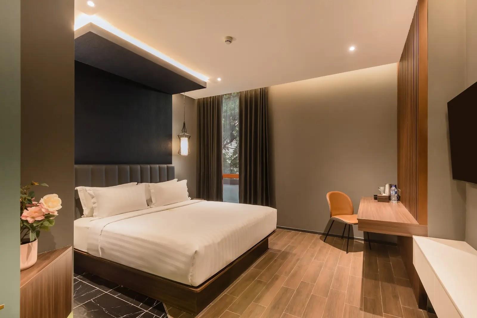 modern hotel room with king bed and desk
