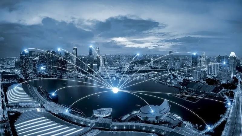 Aerial night cityscape with glowing digital network