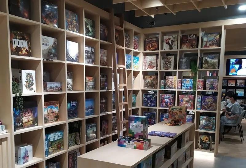 board game shop interior with shelves and display table
