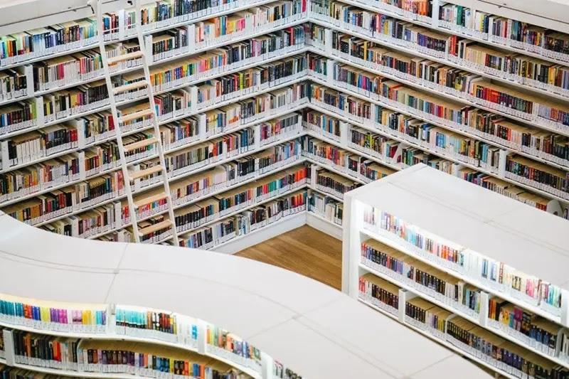 Modern white library interior with colorful books