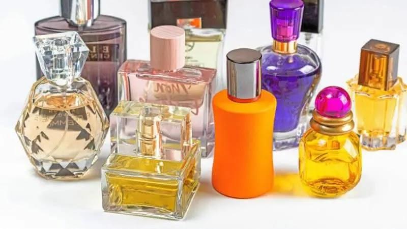 assorted colorful perfume bottles on white background