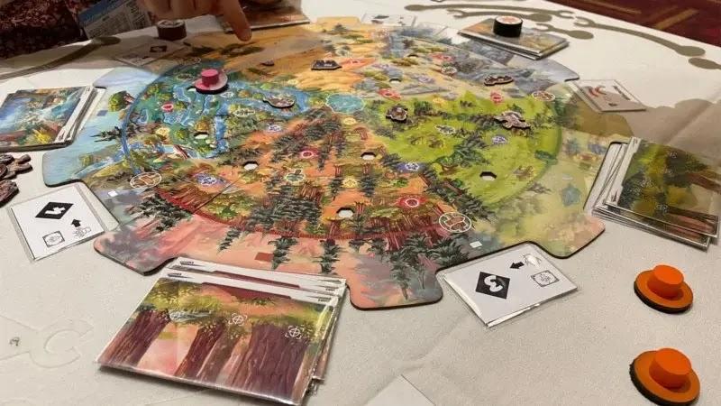 colorful circular board game with cards and tokens