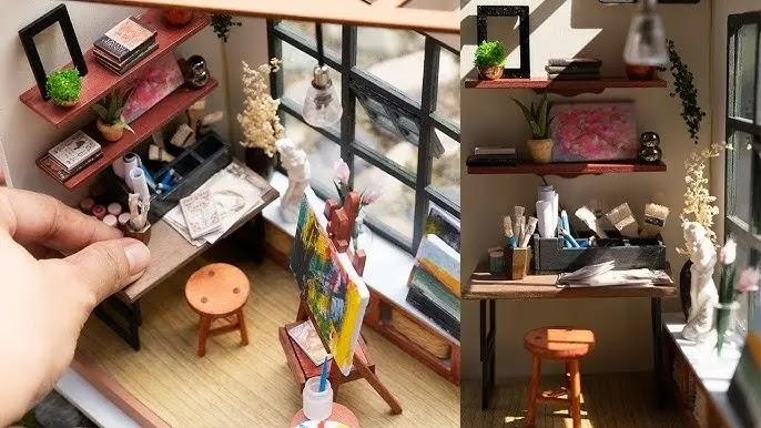 Hand-placed miniature artist studio diorama with easel