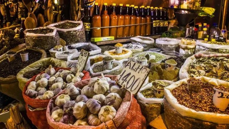 Market stall with garlic bulbs and assorted spices