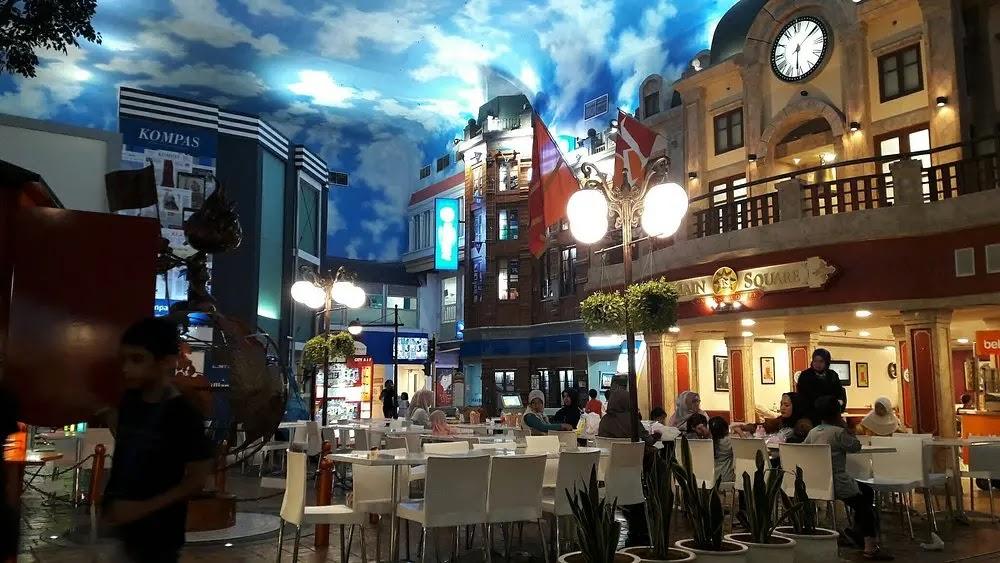 Indoor shopping square with dining area under sky ceiling