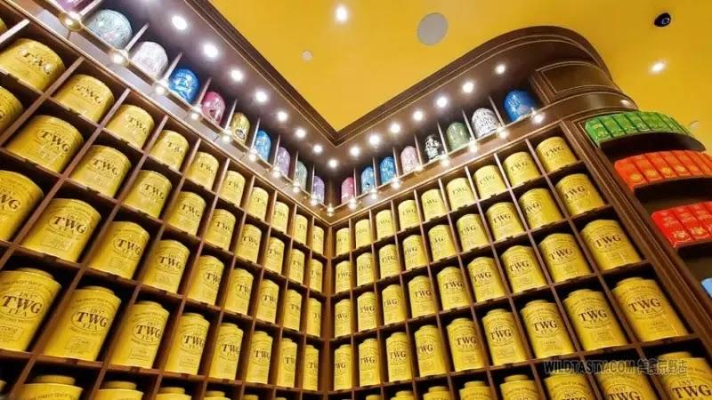 Rows of yellow TWG tea canisters in shop