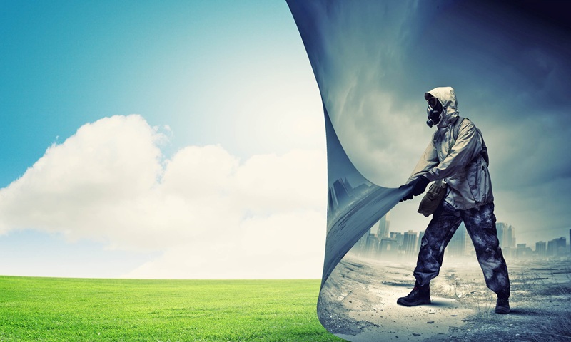 Soldier in tactical gear standing on a cracked surface beside a large torn fabric banner, city skyline behind