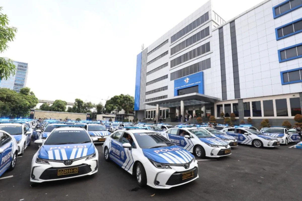 Police cars lined up in front of a modern building during a formal dispatch event