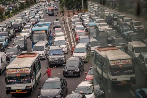 Heavy traffic on a busy highway with many cars and buses, aerial city road view