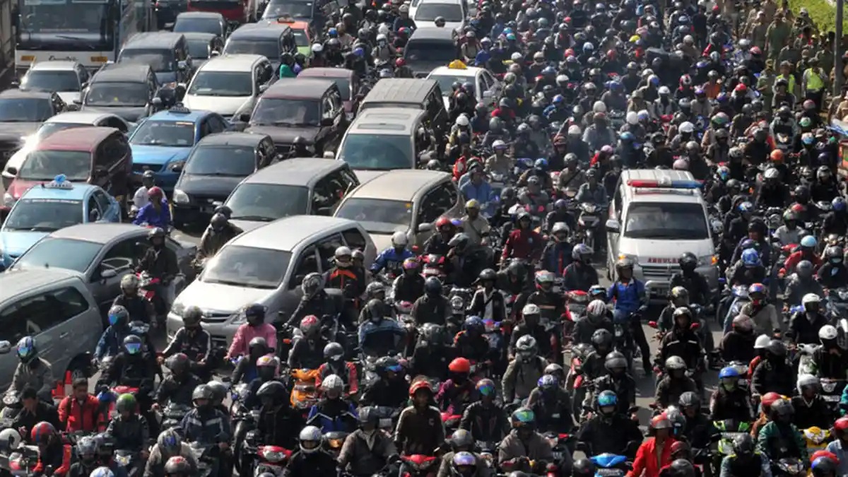 Dense traffic jam with thousands of motorcycles and cars on crowded city streets, viewed from above