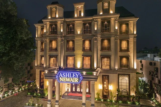 Ashley Newark boutique building facade at night with illuminated windows and street sign