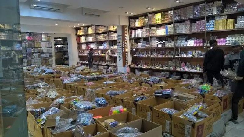 Well-stocked grocery store aisle with rows of packaged goods and boxed products on display shelves