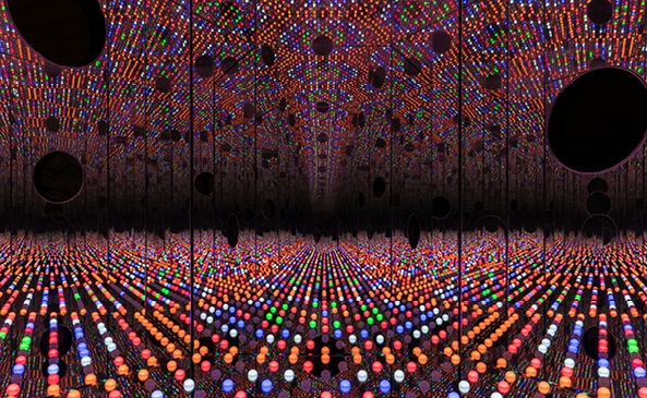 Vibrant LED light display wall filling a large indoor venue with glowing multicolored patterns and reflections