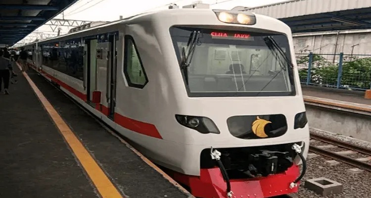 Modern passenger train at a platform with front view and route display signage in station