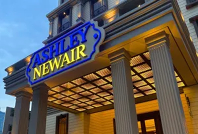 Cashland Newair sign above storefront columns and illuminated entrance at dusk