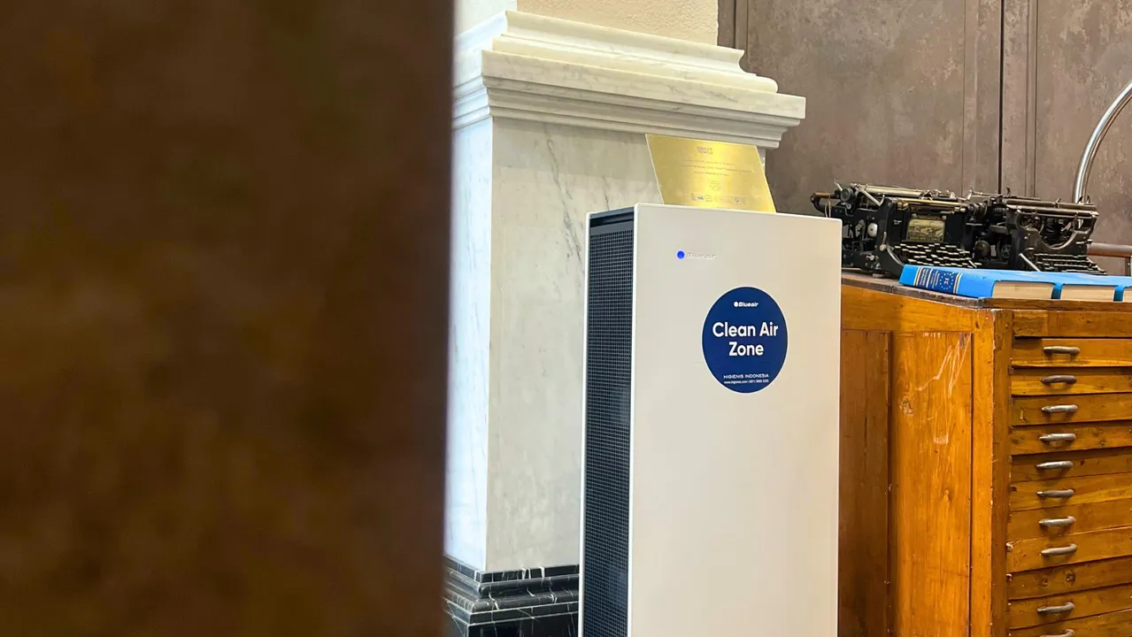 Clean Air Zone air purifier unit with white cabinet and grill filter in an industrial room