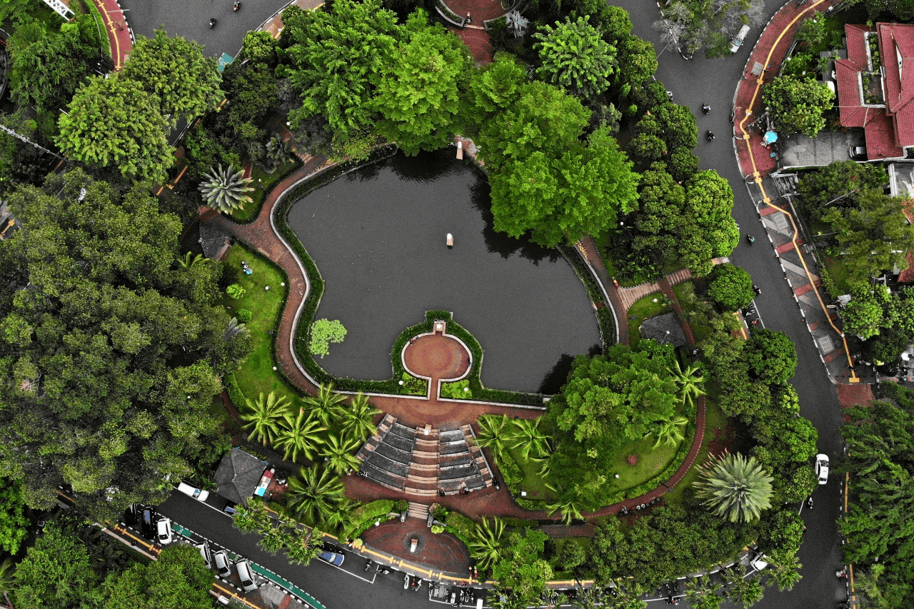 aerial view of a park with a pond and walkways