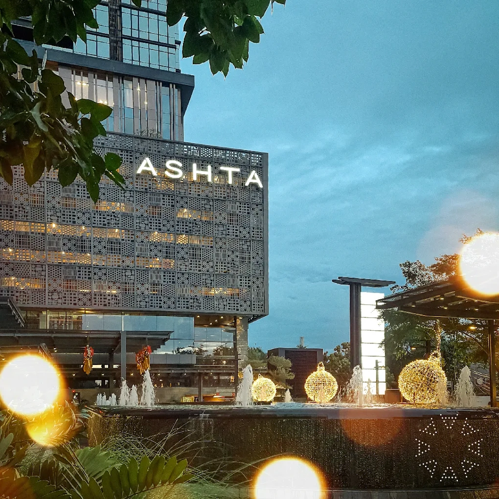 ashta district 8 building with decorative fountain and lights