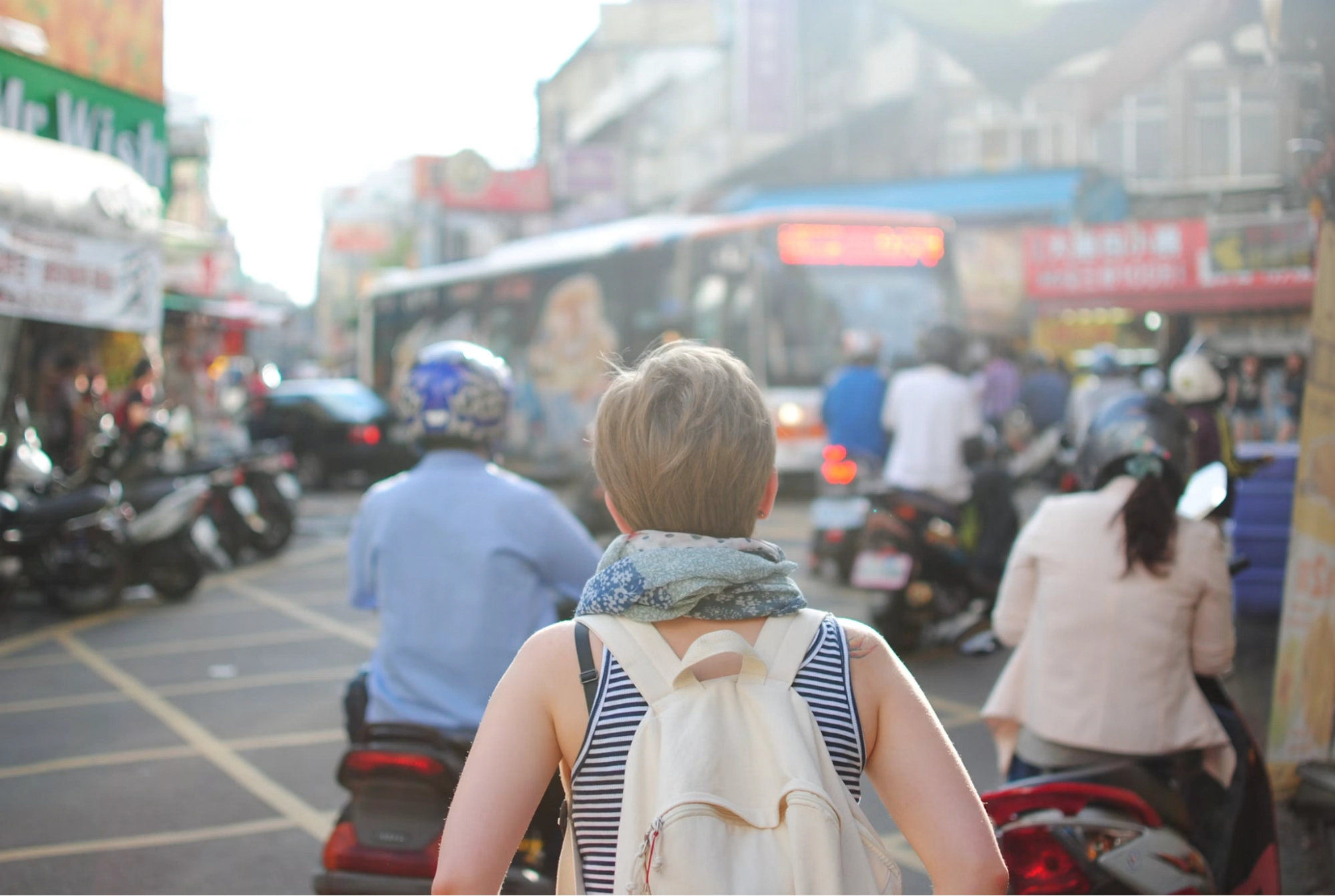 backpacker walking through a busy city street