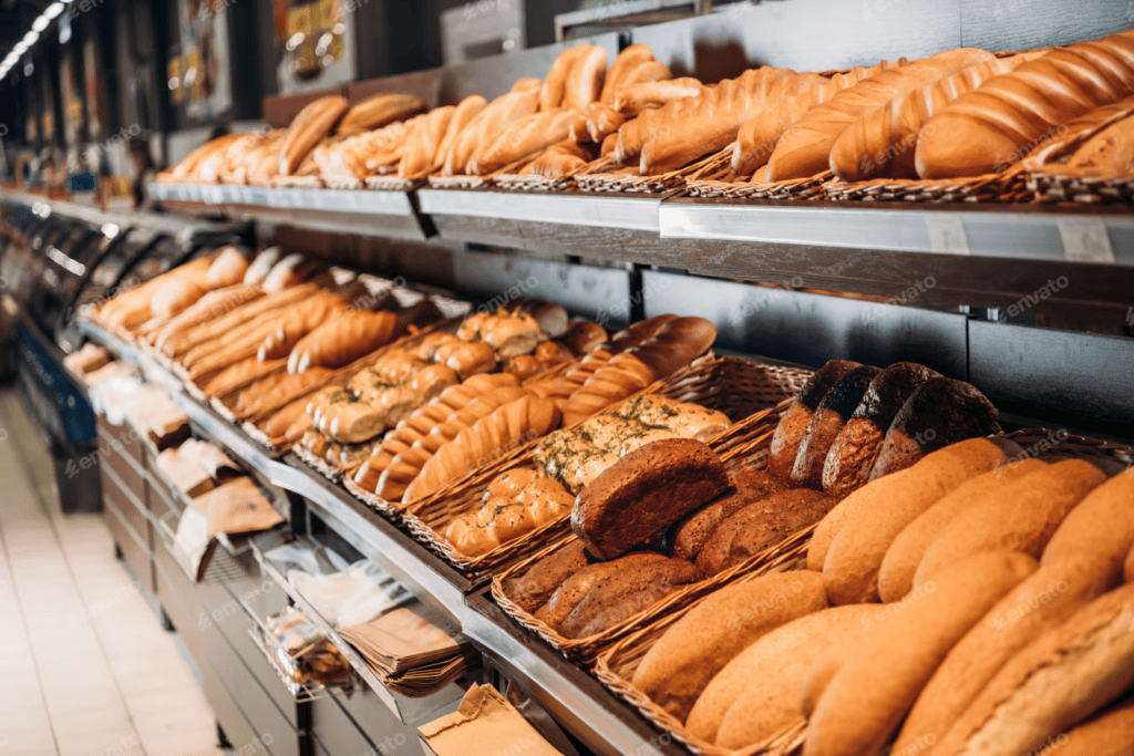 bakery display shelves stacked with various fresh bread loaves