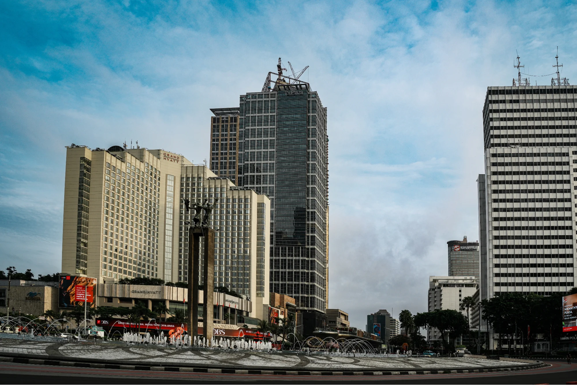 bundaran hi fountain roundabout surrounded by high-rise city skyscrapers