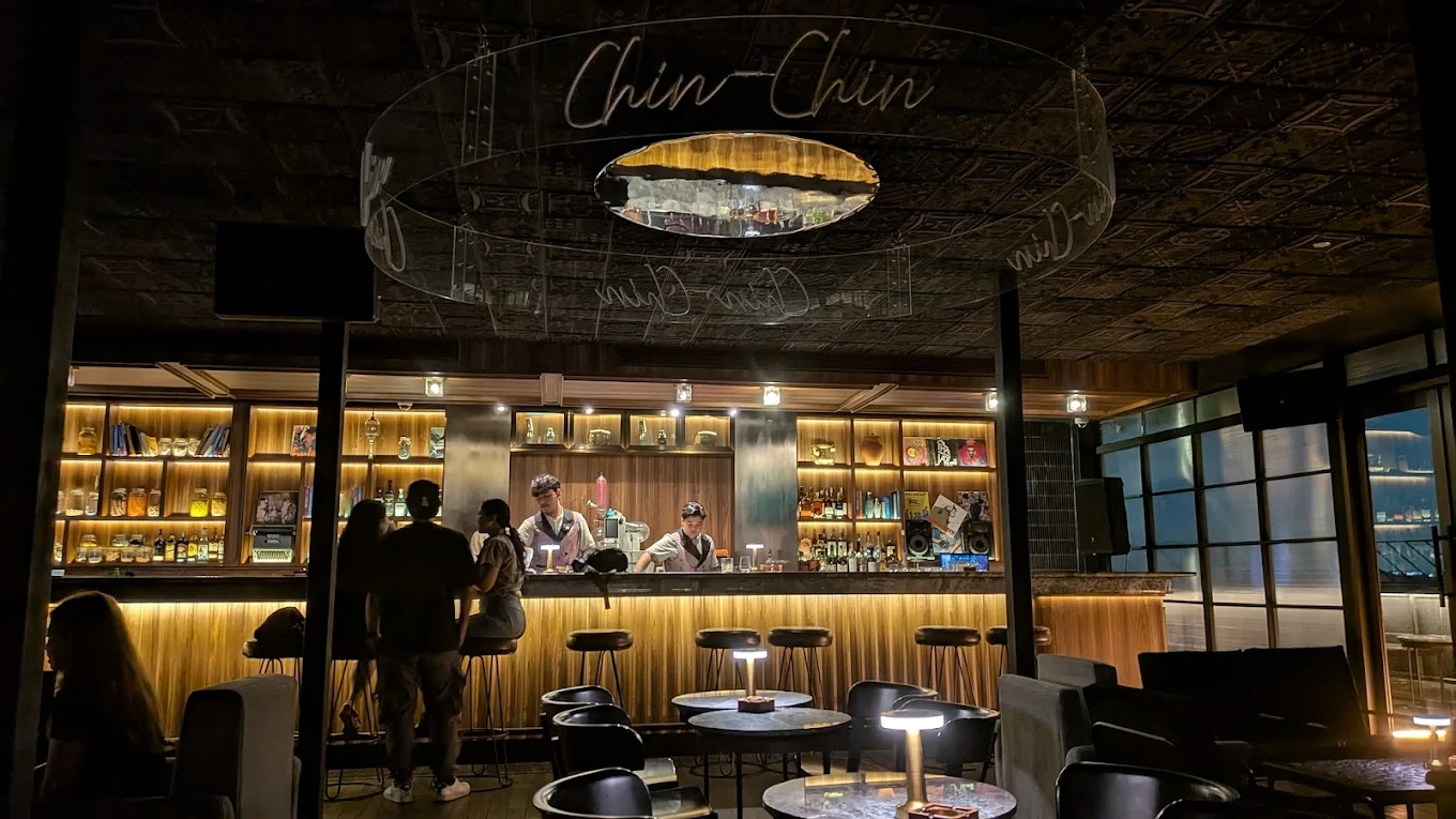 chin chin bar interior with illuminated liquor shelves and cozy lounge seating