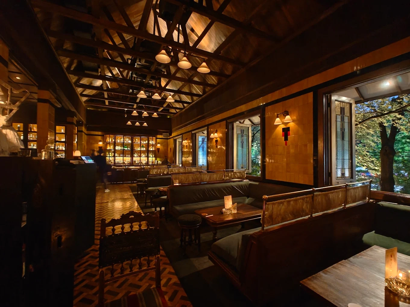 cozy lounge bar with wooden ceiling and plush seating
