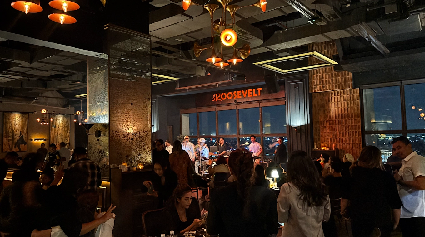 crowded lounge bar with live stage performance