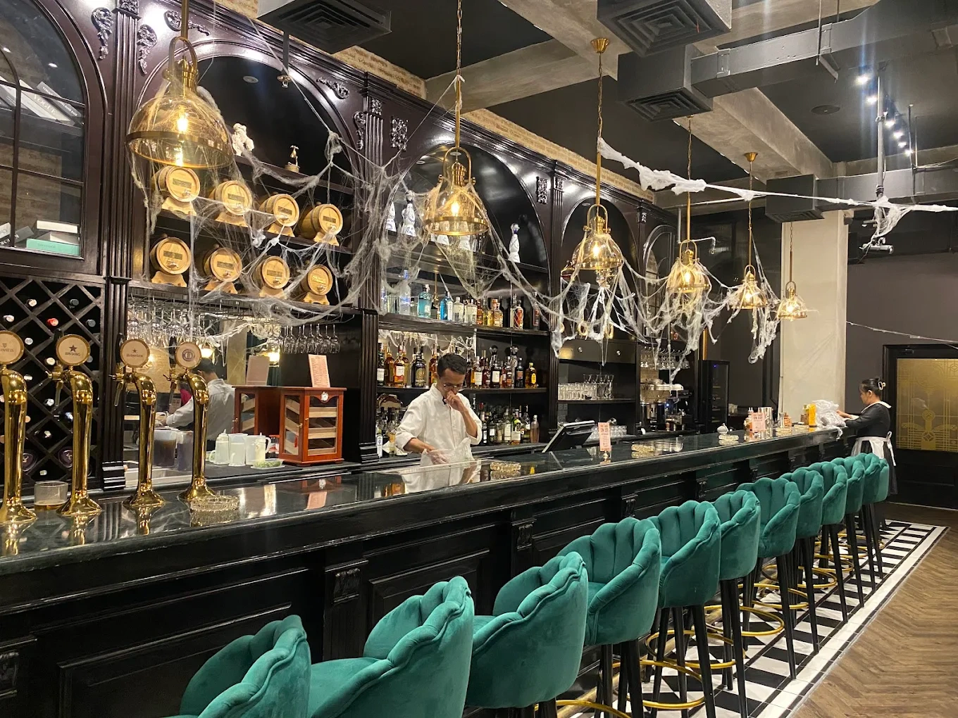 dark wood bar decorated with halloween cobwebs