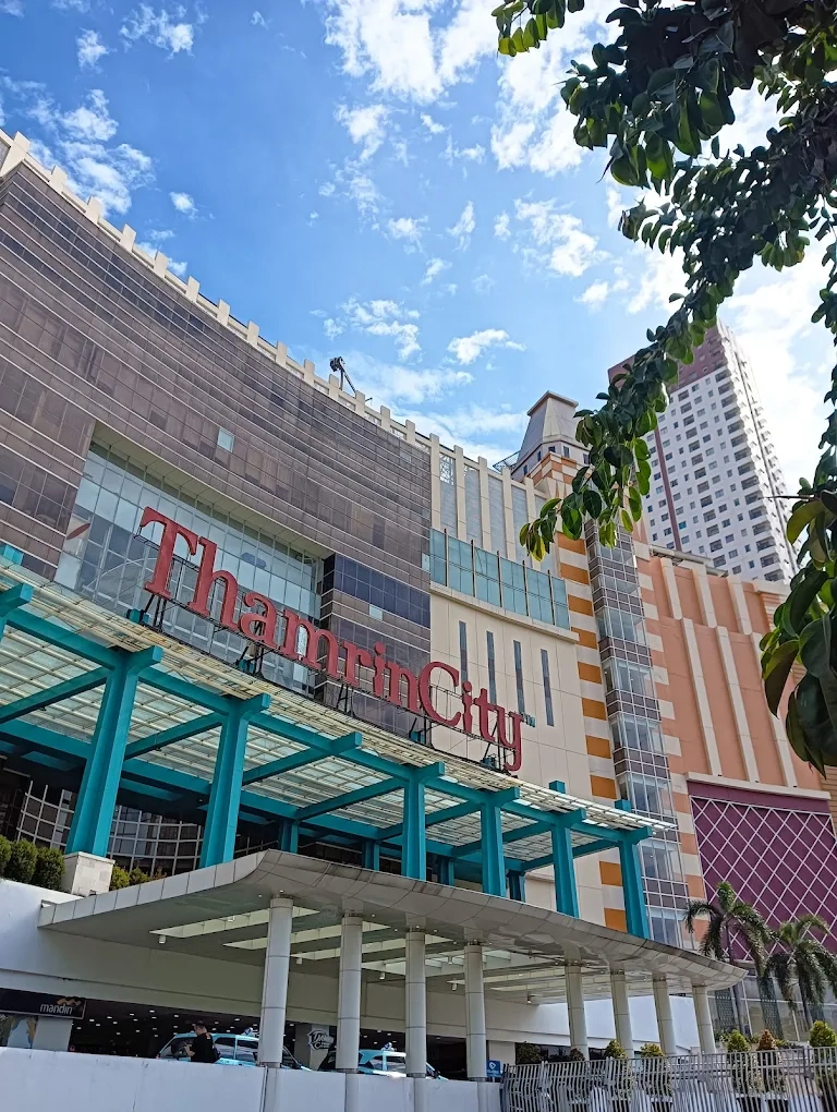 exterior view of thamrin city shopping mall building under a bright blue sky