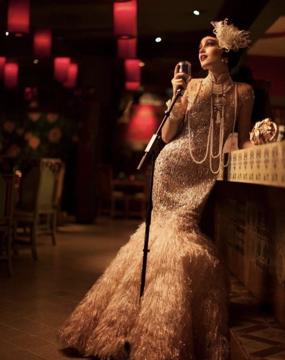 female singer performing in a sparkling vintage gown