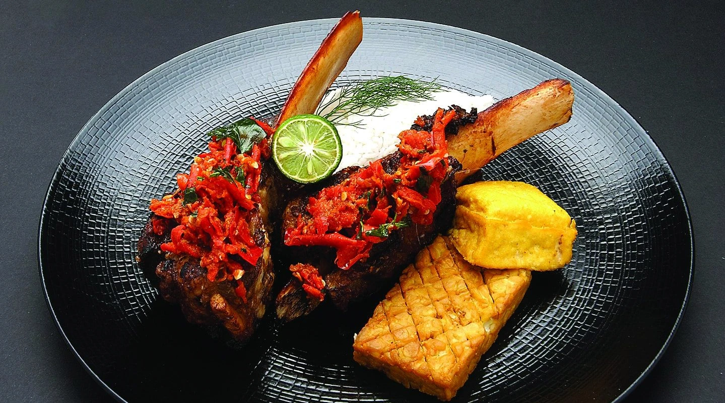 grilled beef ribs topped with red sambal served with tempeh tofu and rice