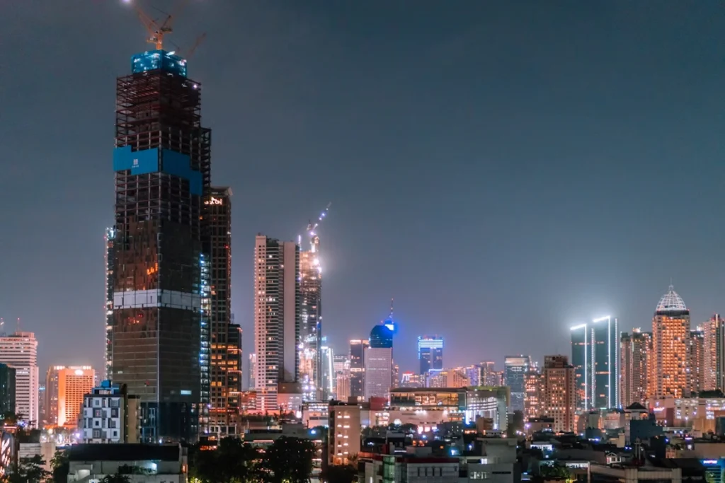 illuminated city skyline and skyscrapers at night