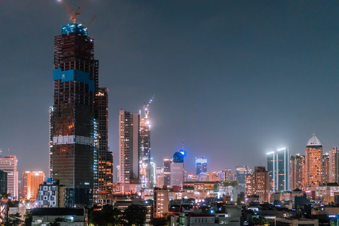 illuminated city skyline and skyscrapers at night
