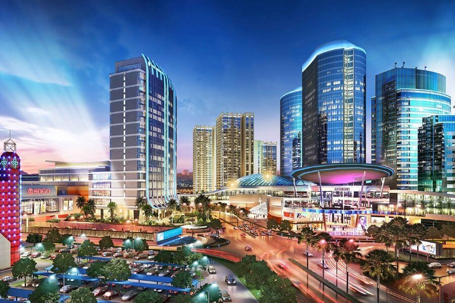 illuminated modern city complex at dusk with glass skyscrapers and shopping center