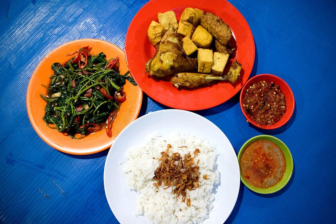 indonesian meal with fried chicken tofu tempeh kangkung and rice