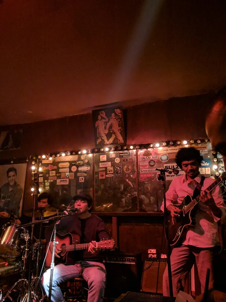 live band performing on stage in a retro venue