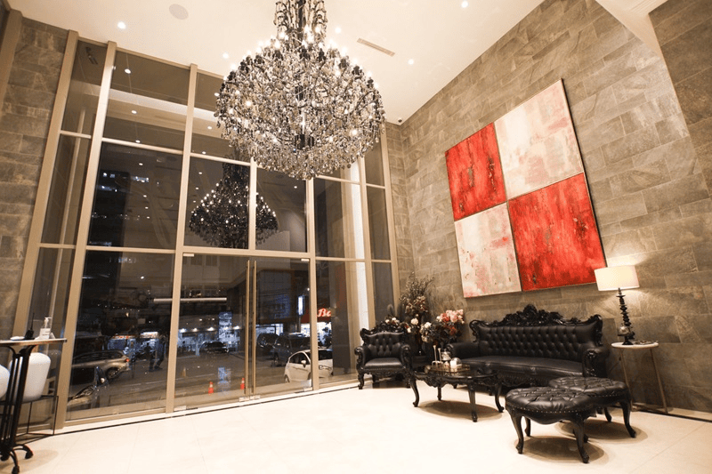 luxury lobby with crystal chandelier and black leather sofa