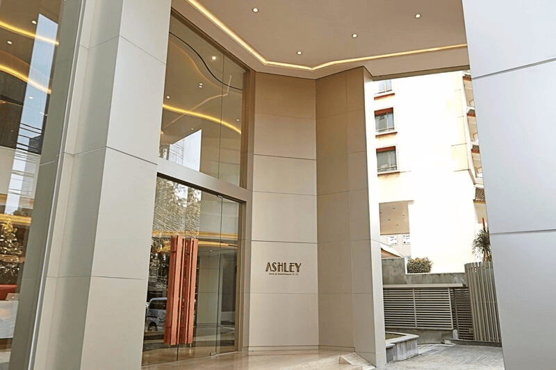 modern building entrance with a glass door and sign