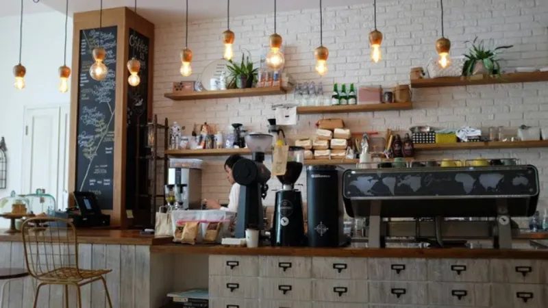 modern coffee shop counter with hanging lights and equipment