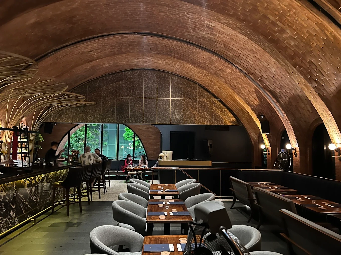 modern restaurant with a grand brick arched ceiling